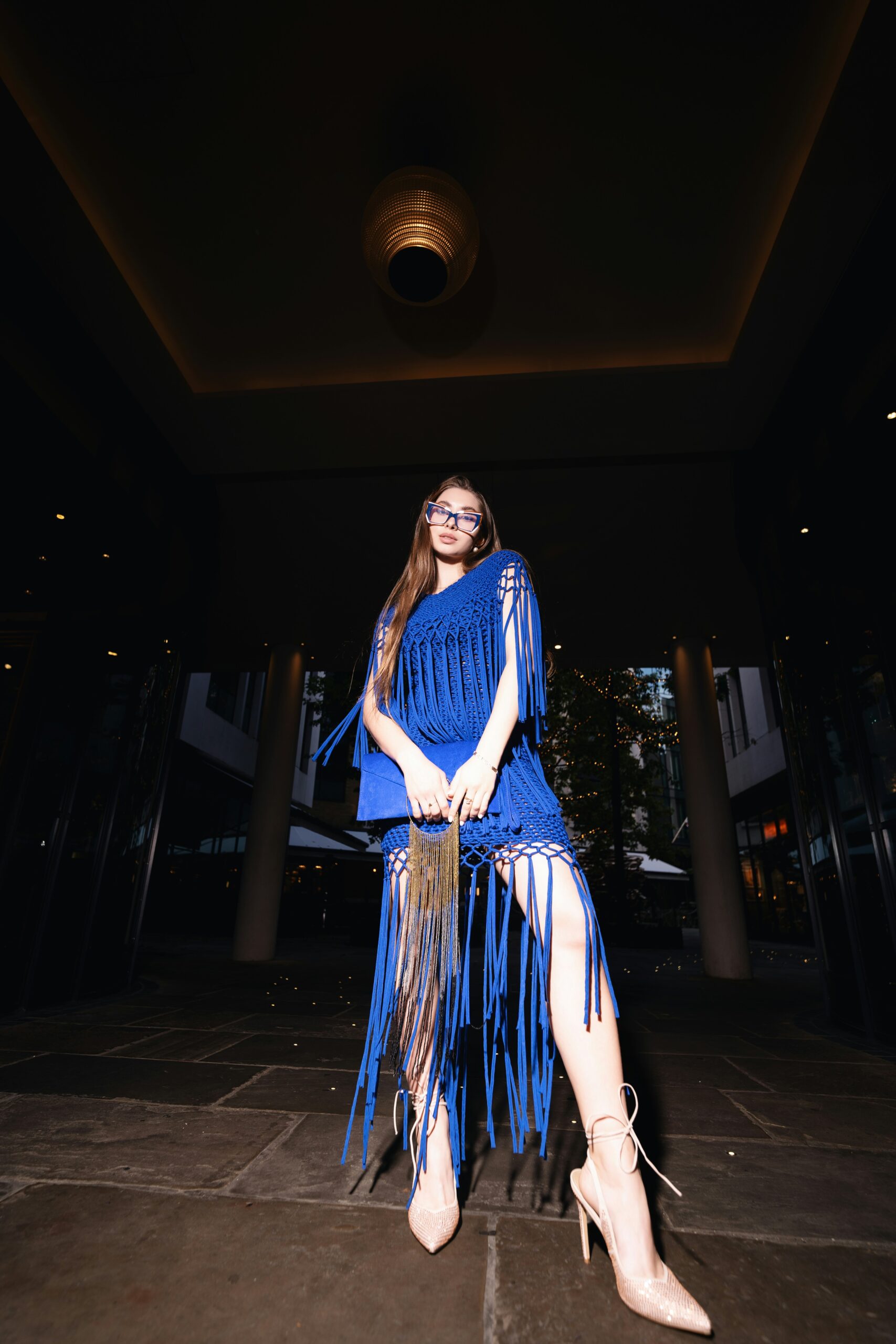A woman in a blue dress sitting on a chair